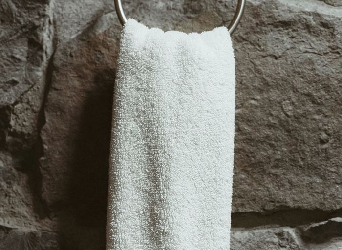 Towel on a ring mounted against a stone wall