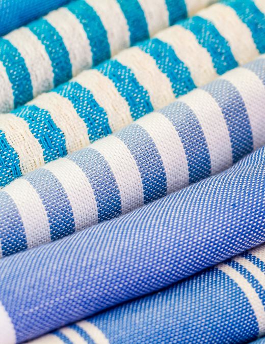 Blue and teal striped rolled beach towels